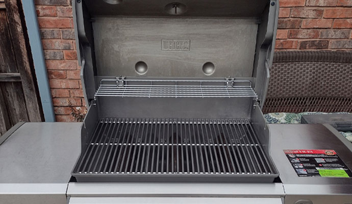 Worker cleaning grill